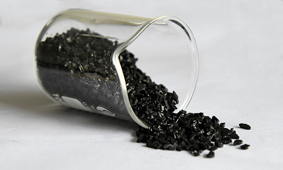 Granular coconut shell activated carbon in laboratory beaker for CIP and CIL gold recovery